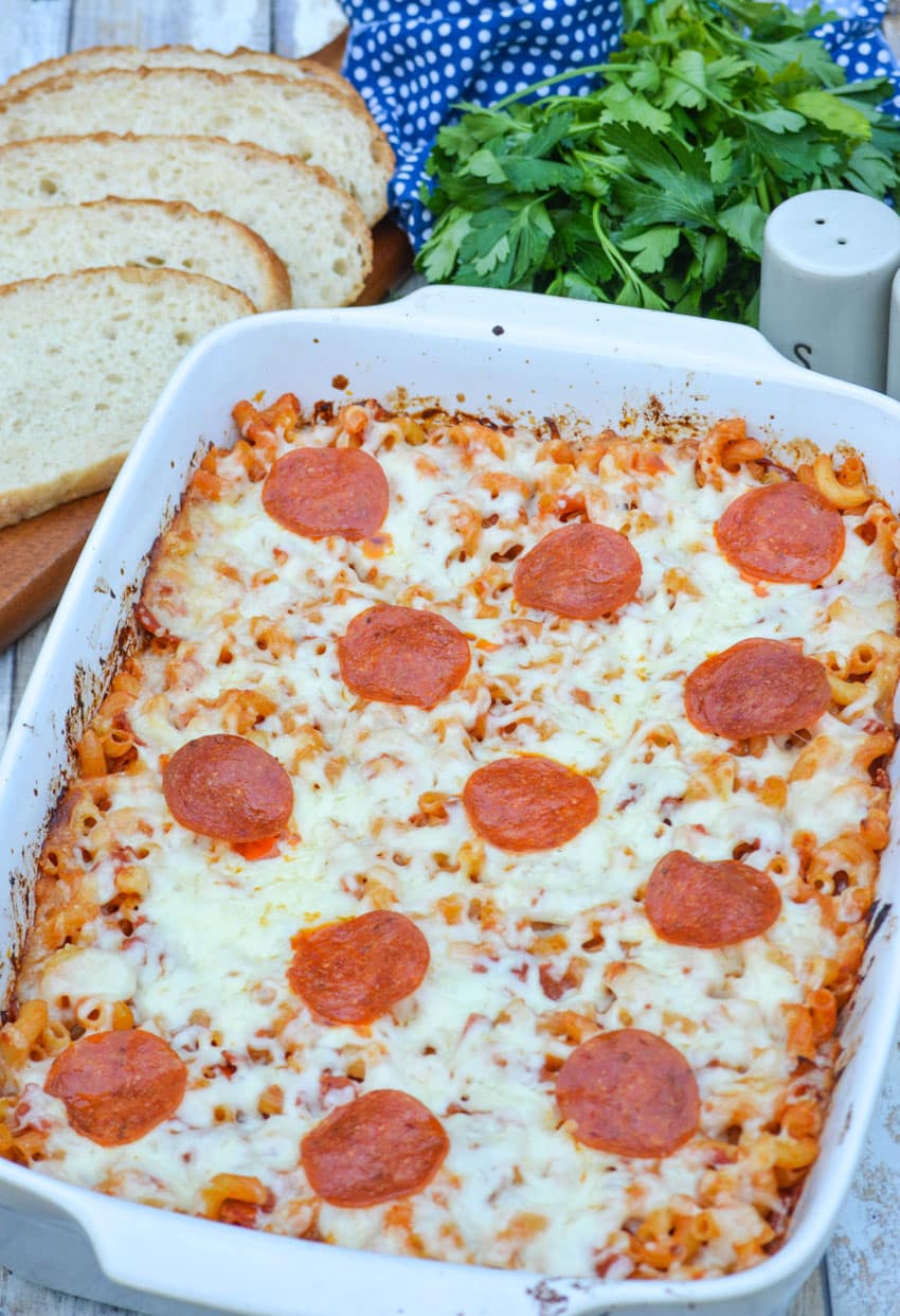 pepperoni topped pizza casserole in a white baking dish