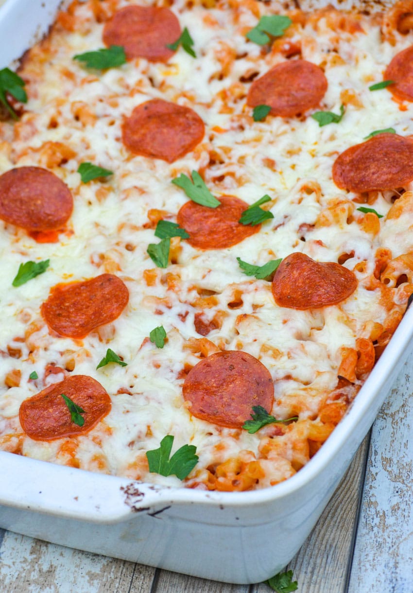 pepperoni topped pizza casserole in a white baking dish