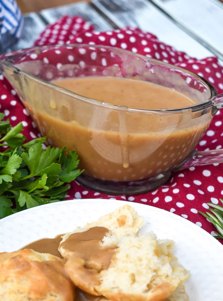 make ahead turkey gravy over biscuits shown on a white plate