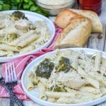 slow cooker chicken alfredo with broccoli served on white plates