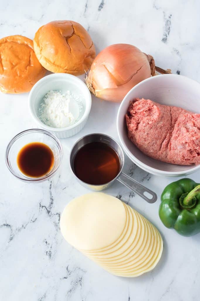an overhead image showing the measured ingredients needed to make a batch of slow cooker philly cheesesteak sloppy joes