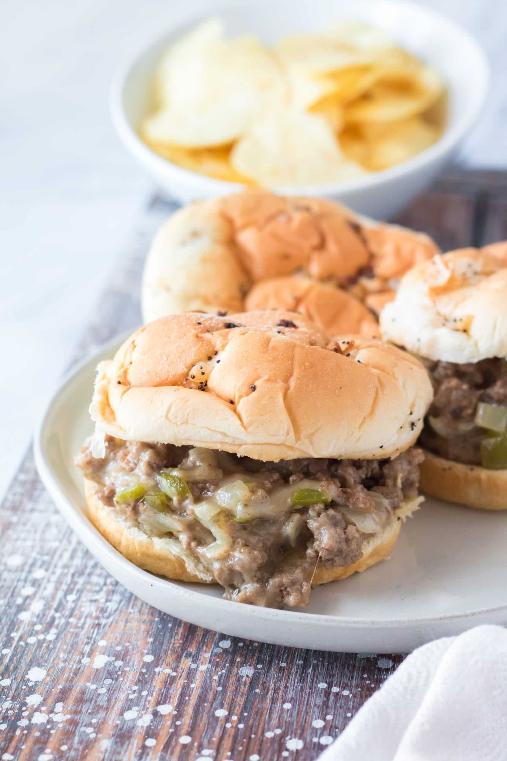 Slow Cooker Philly Cheesesteak Sloppy Joes slow cooker philly cheesesteak sloppy joes on a white plate