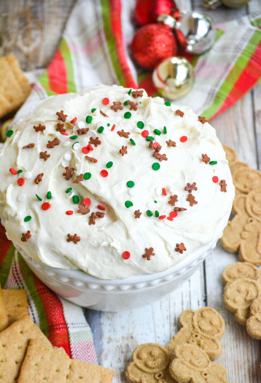 three ingredient sugar cookie dip in a white bowl topped with festive sprinkles