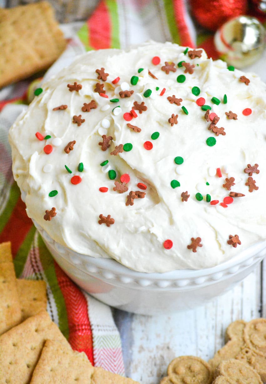 fluffy sugar cookie dip topped with sprinkles in a white bowl