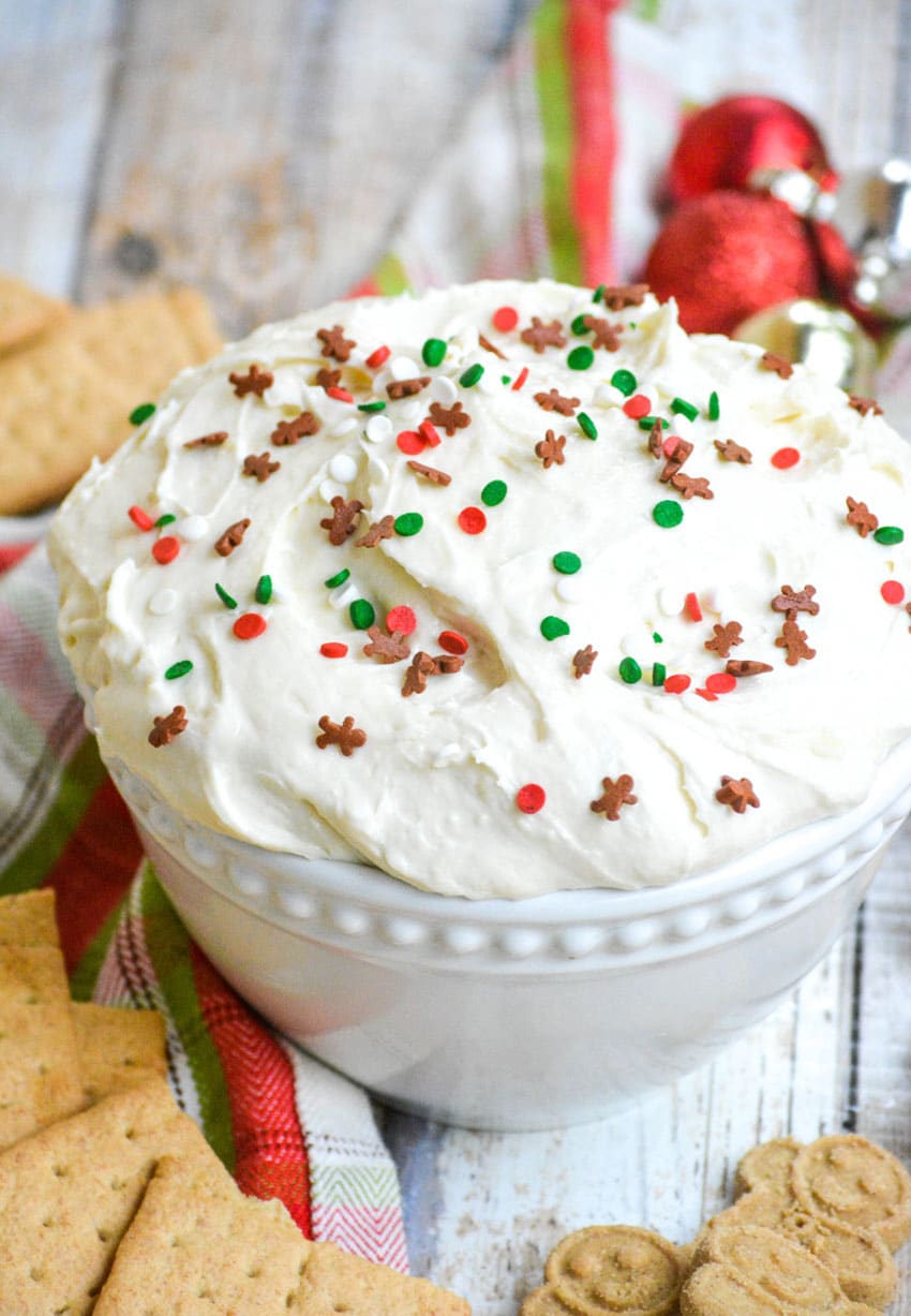 three ingredient sugar cookie dip in a white bowl topped with festive sprinkles