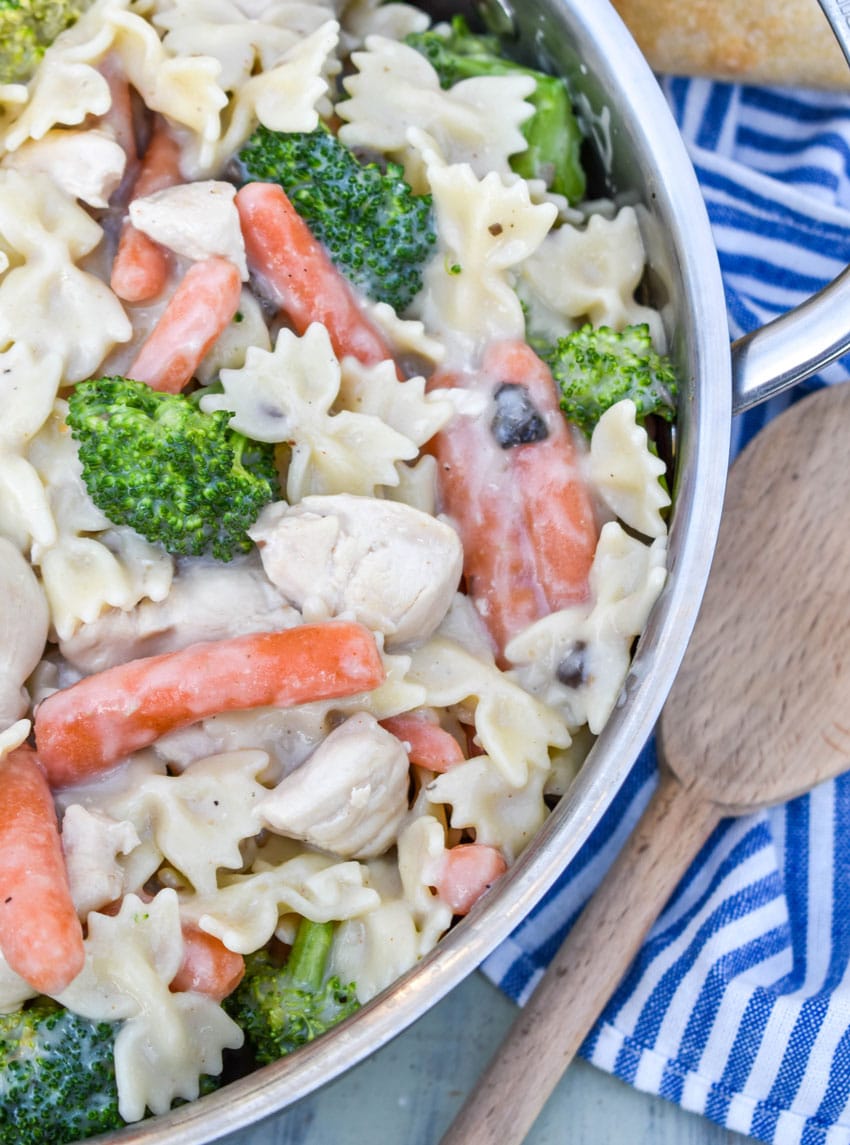 creamy chicken and bowtie pasta in a metal pot