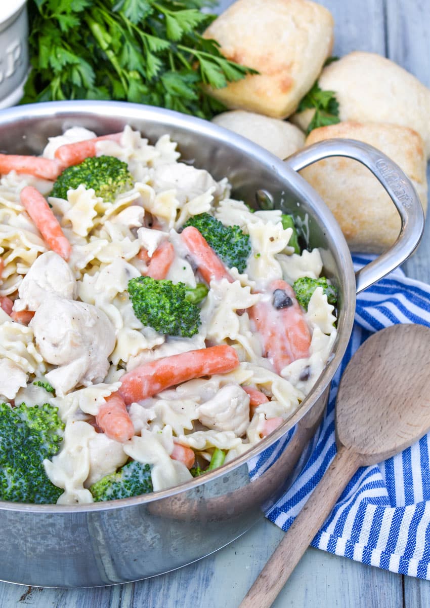 creamy chicken and bowtie pasta in a metal pot