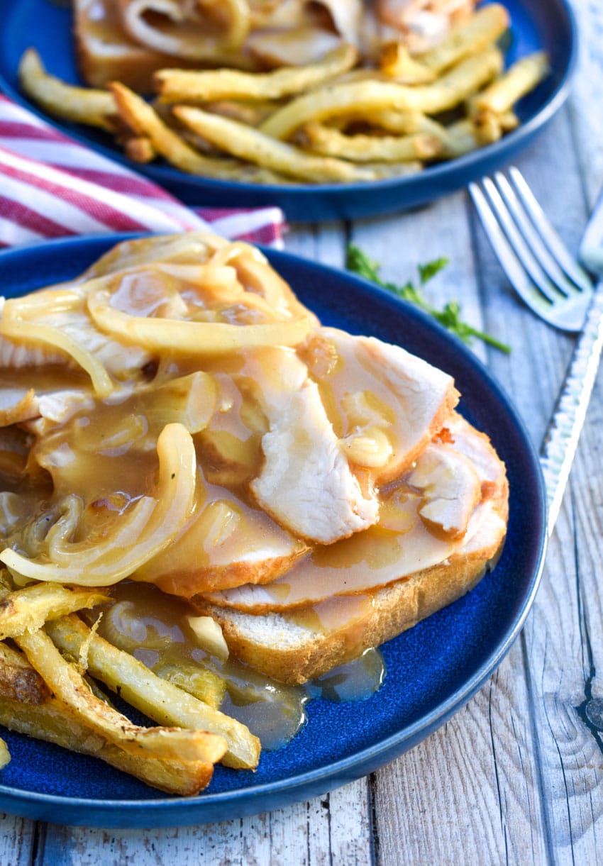 Diner Style Hot Turkey Sandwiches on a blue plate with crispy french fries on the side