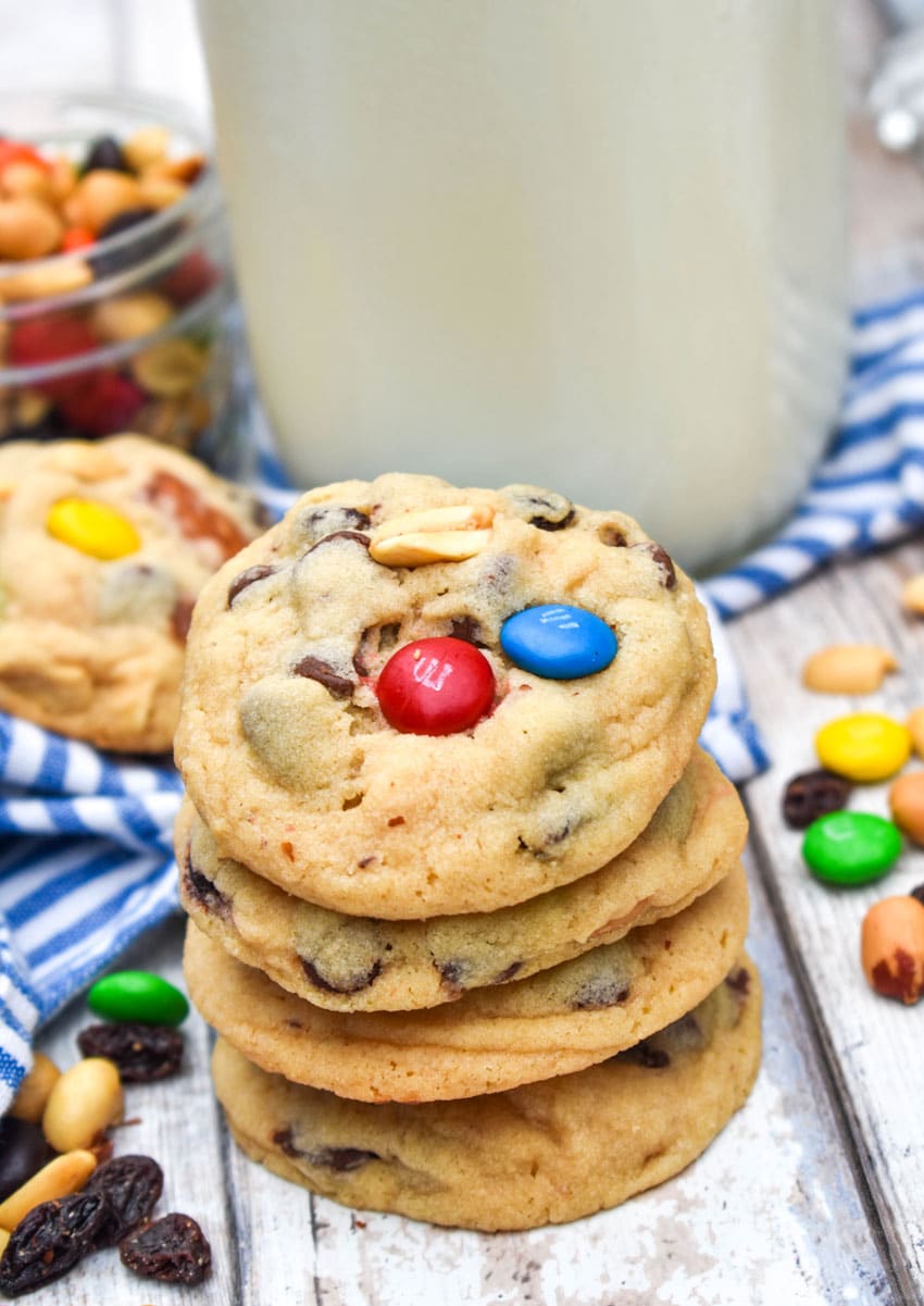a stack of trail mix cookies on a wooden table