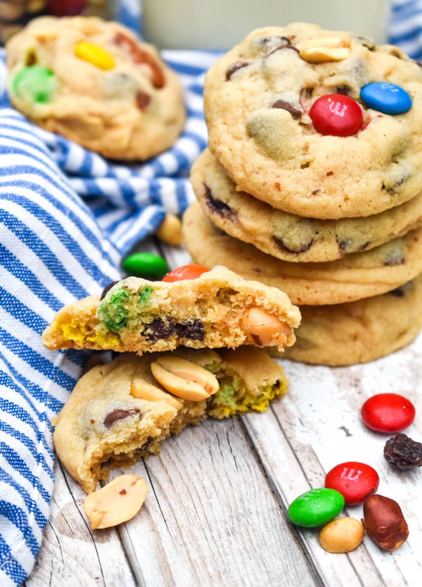 a stack of trail mix cookies on a wooden table