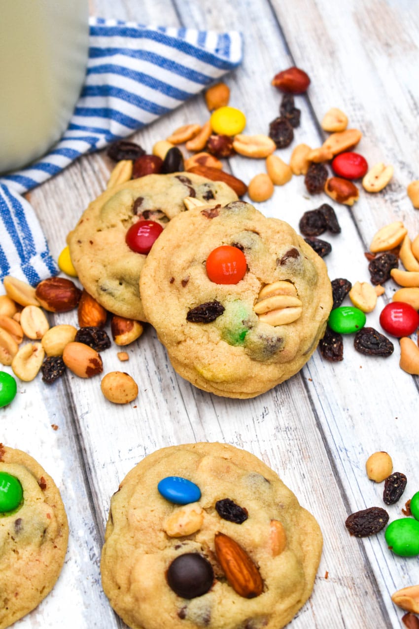 quick and easy trail mix cookies surrounded by trail mix on a wooden table