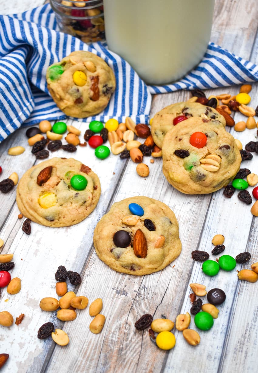 quick and easy trail mix cookies surrounded by trail mix on a wooden table