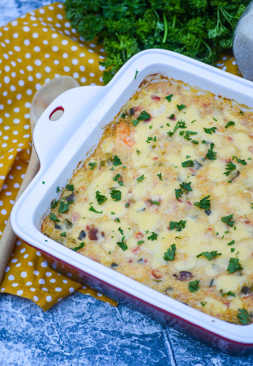 shrimp and grits casserole in a square baking dish