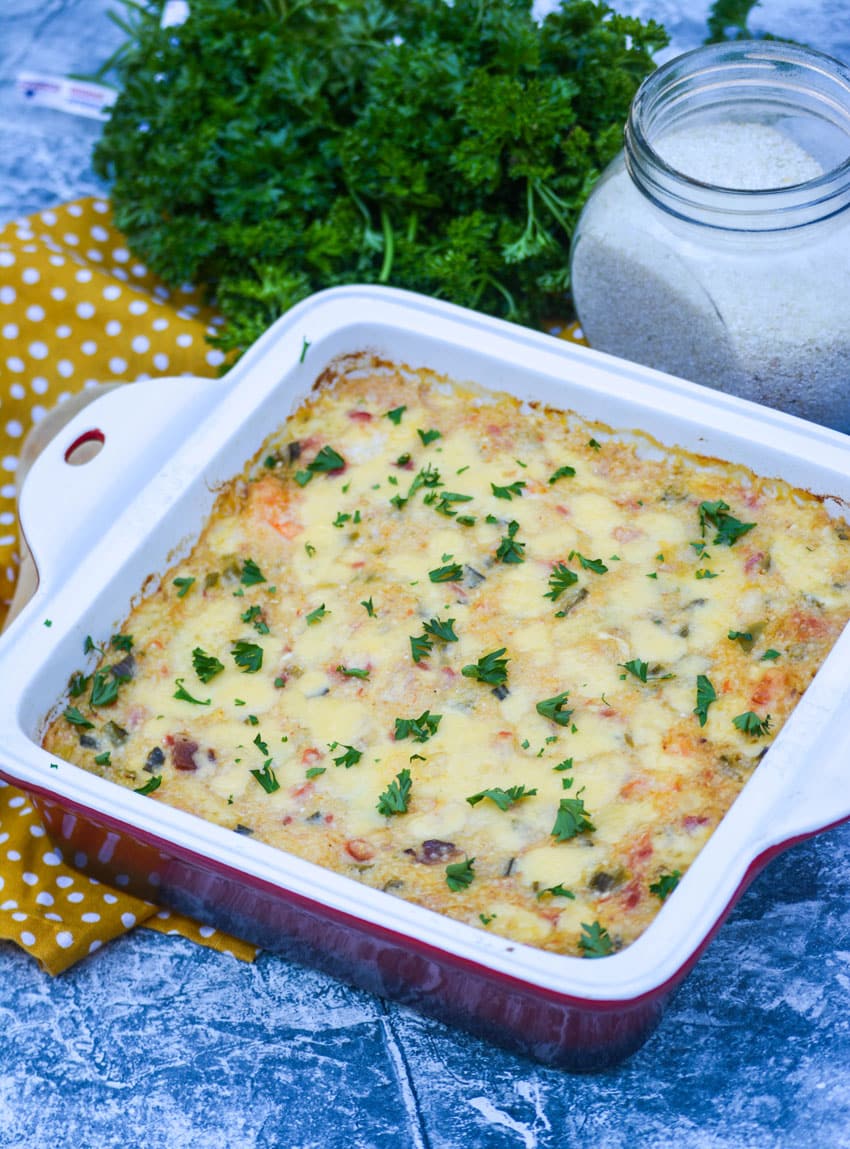 shrimp and grits casserole in a square baking dish