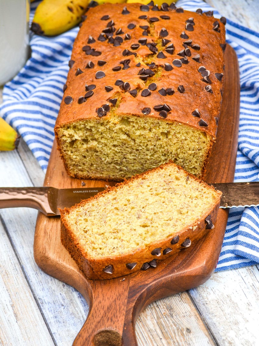 a sliced loaf of banana bread made with cake mix on a wooden cutting board