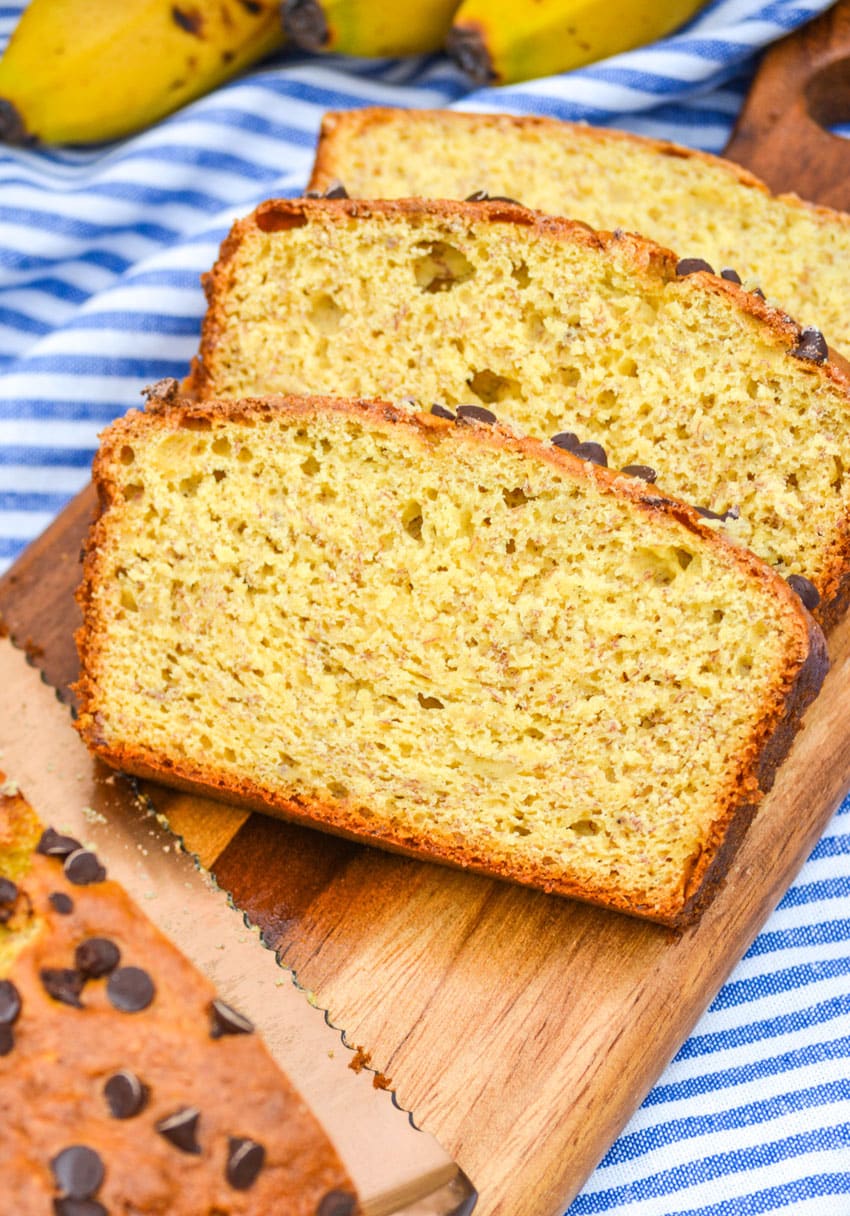 three slices of quick and easy banana bread with cake mix on a wooden cutting board