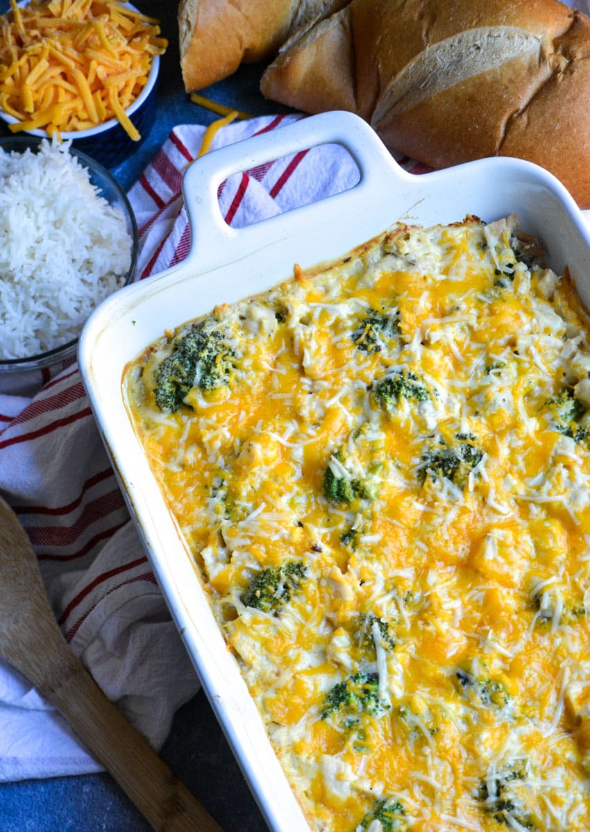 Cheesy chicken divan casserole in a white baking dish
