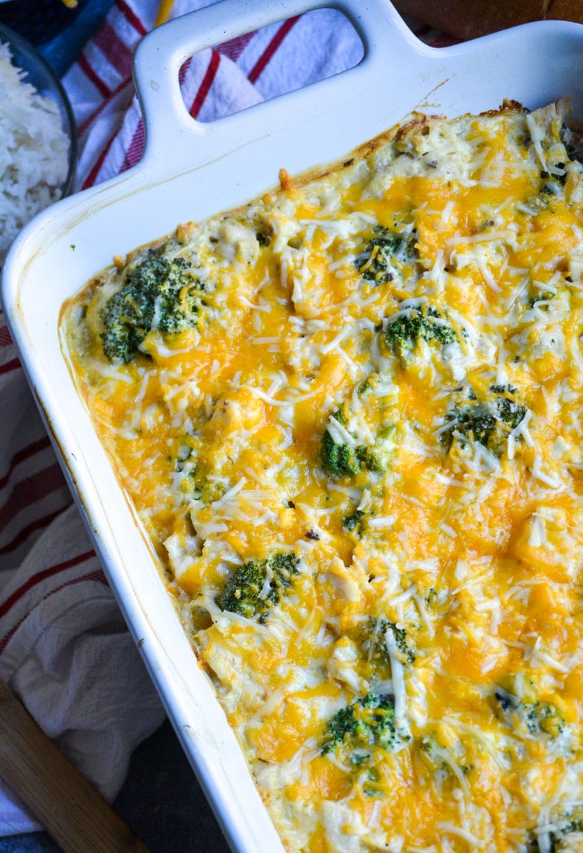 Cheesy chicken divan casserole in a white baking dish