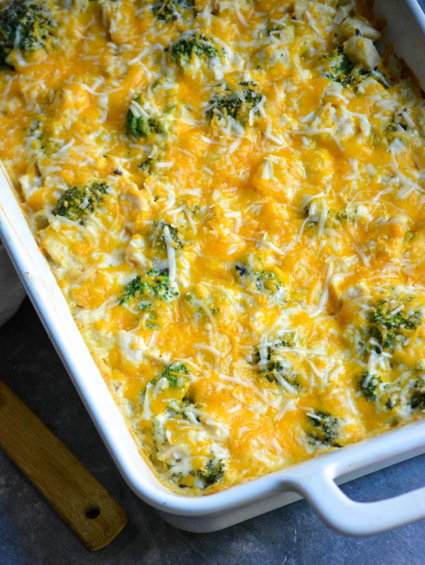 Cheesy chicken divan casserole in a white baking dish