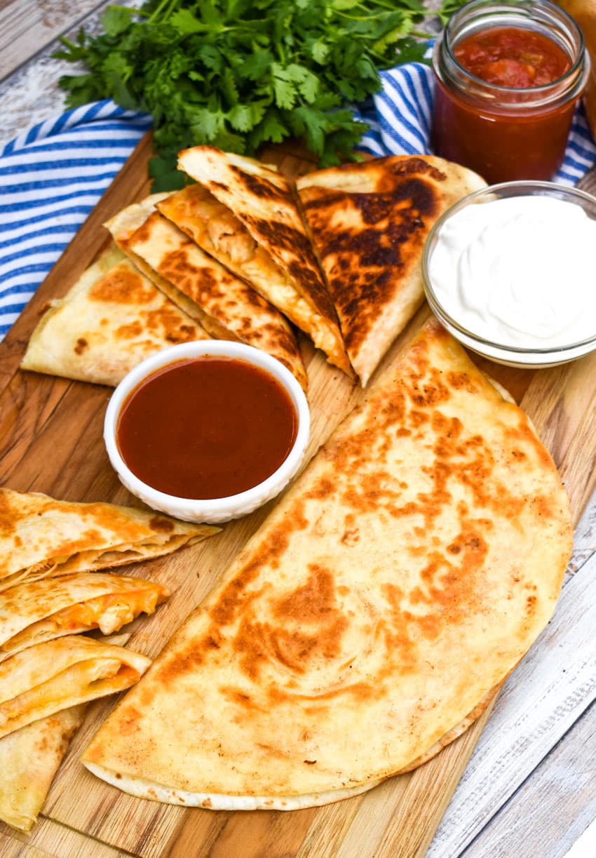 copycat Taco Bell chicken quesadilla on a wooden cutting board