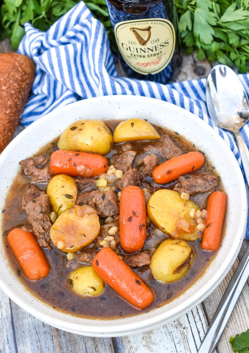 slow cooker guinness beef stew in a white soup bowl
