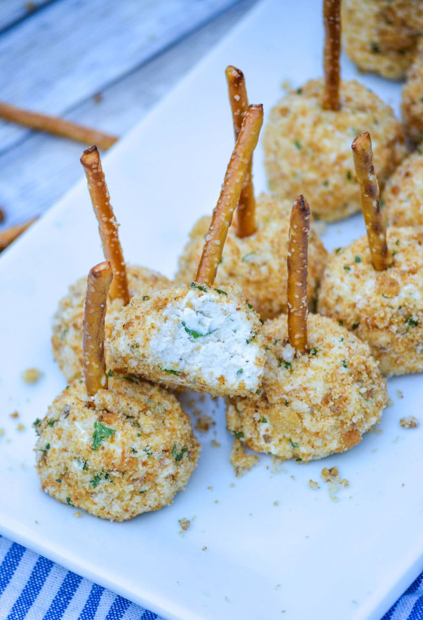 mini goat cheese balls on a white serving platter