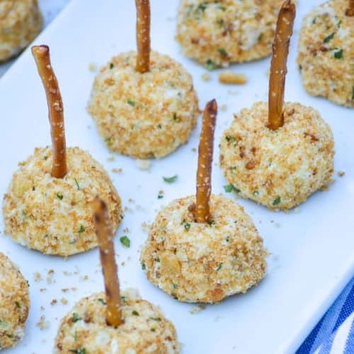 mini goat cheese balls on a white serving platter