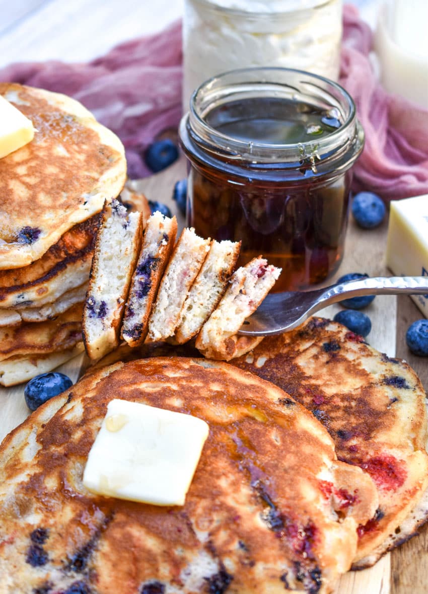 slices of mixed berry pancakes on a silver fork