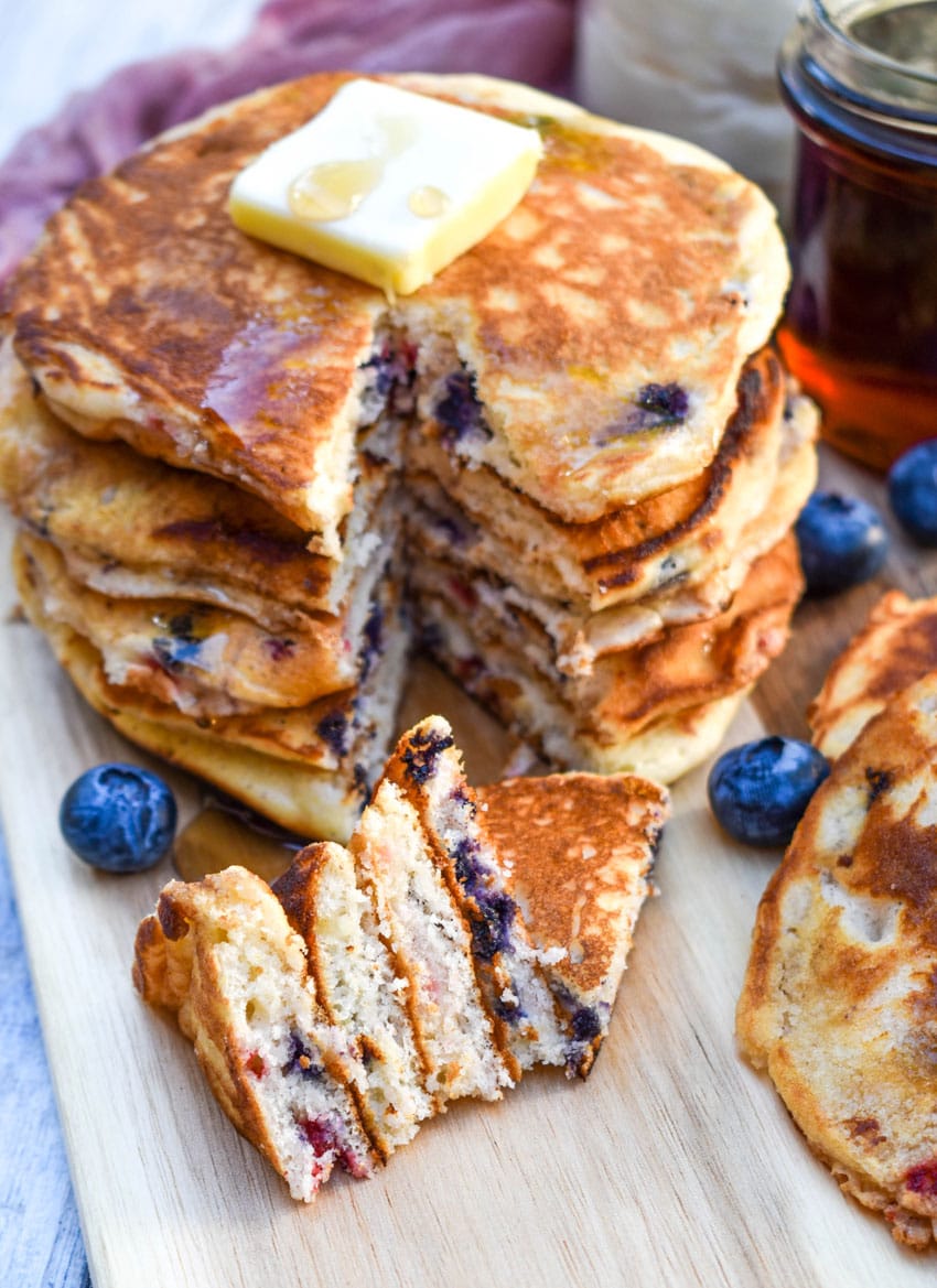 slices of mixed berry pancakes on a wooden cutting board