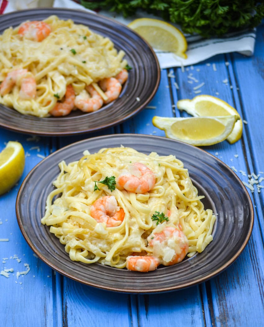 baked shrimp scampi casserole on small round brown plates