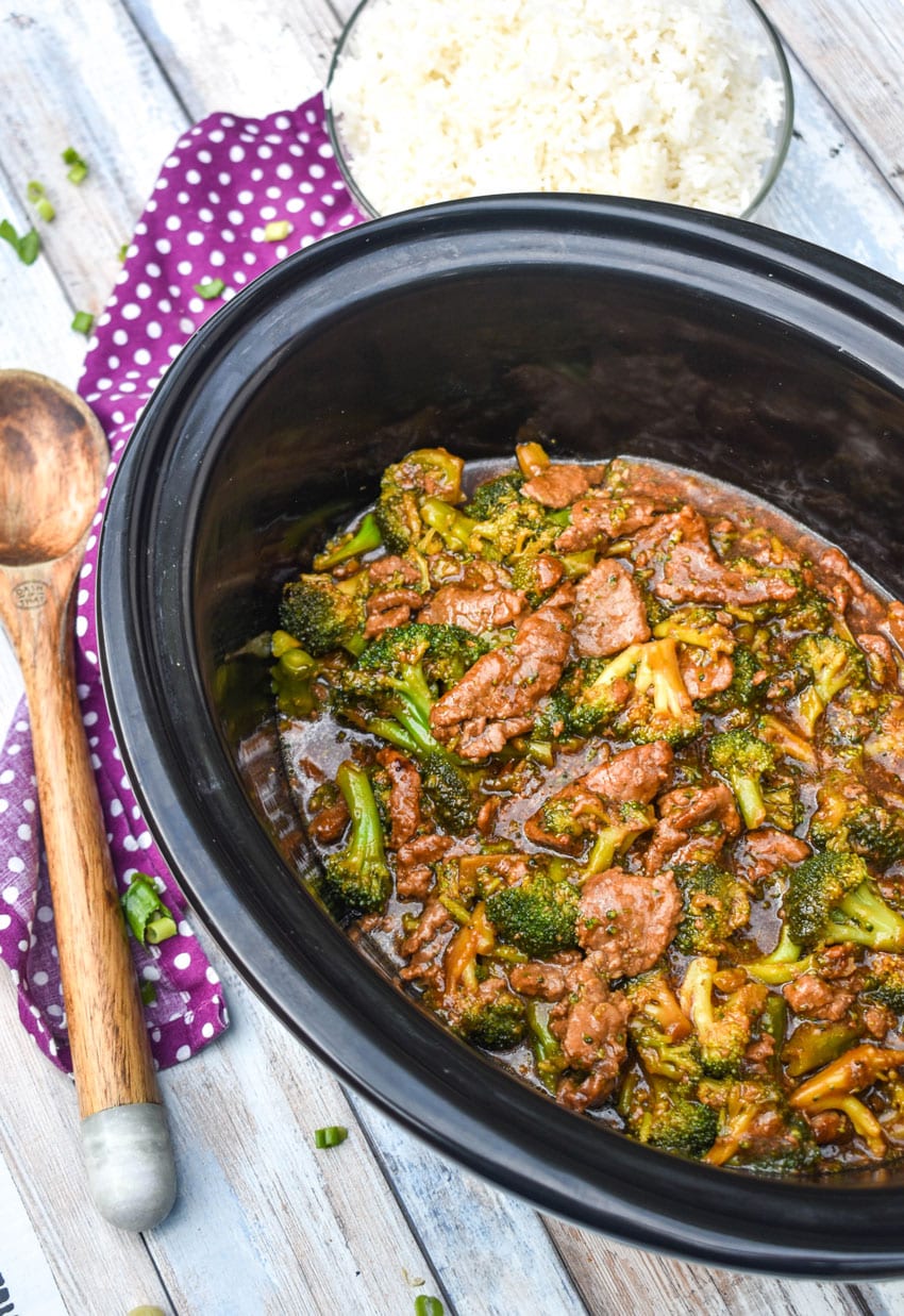 saucy slow cooker beef and broccoli in the black bowl of crockpot