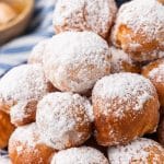 canned biscuit beignets piled on a blue and white plate