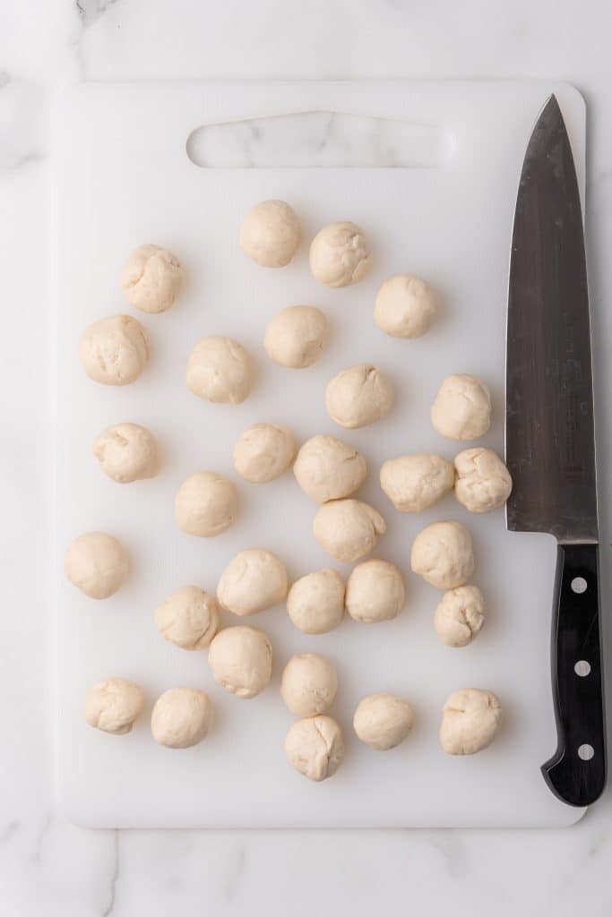 biscuit dough balls on a white cutting board