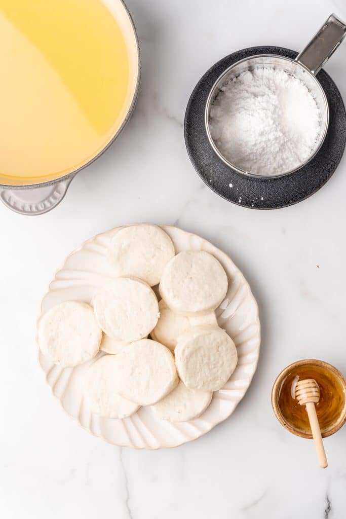an overhead image showing the measured ingredients needed to make a batch of quick and easy homemade beingets