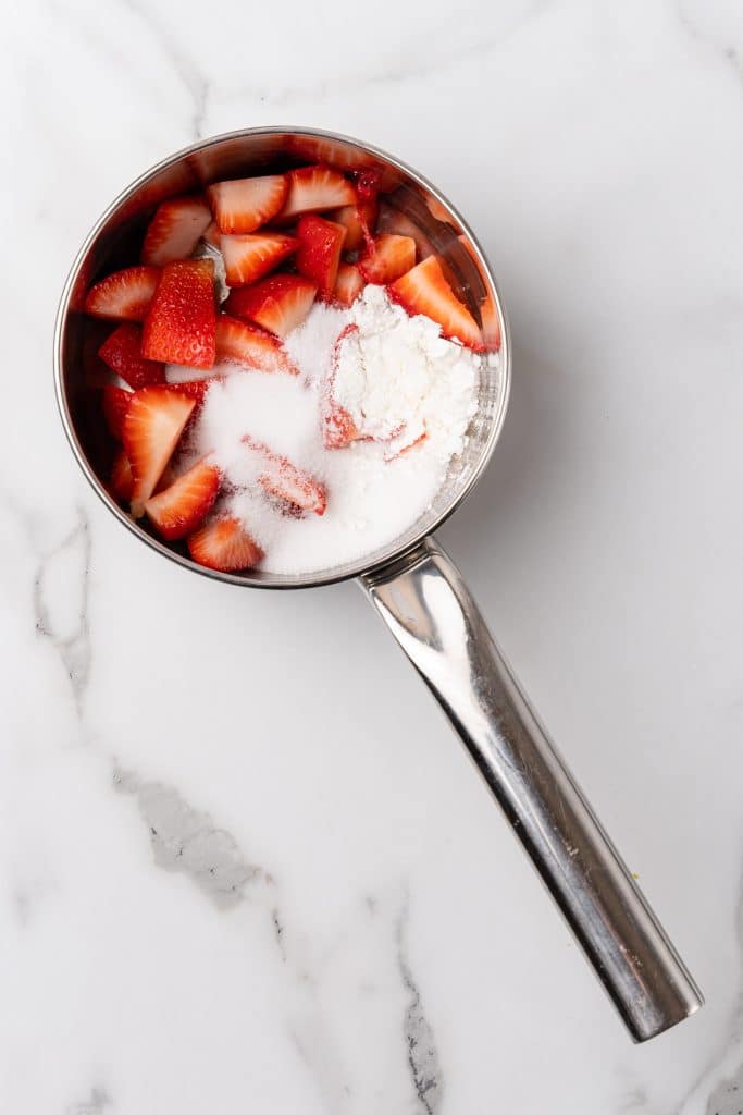 chopped strawberries and cornstarch in a small metal pot