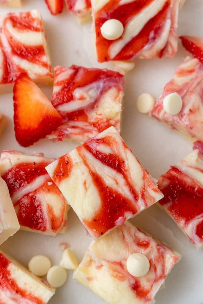 squares of strawberries and cream fudge on a marble counter top