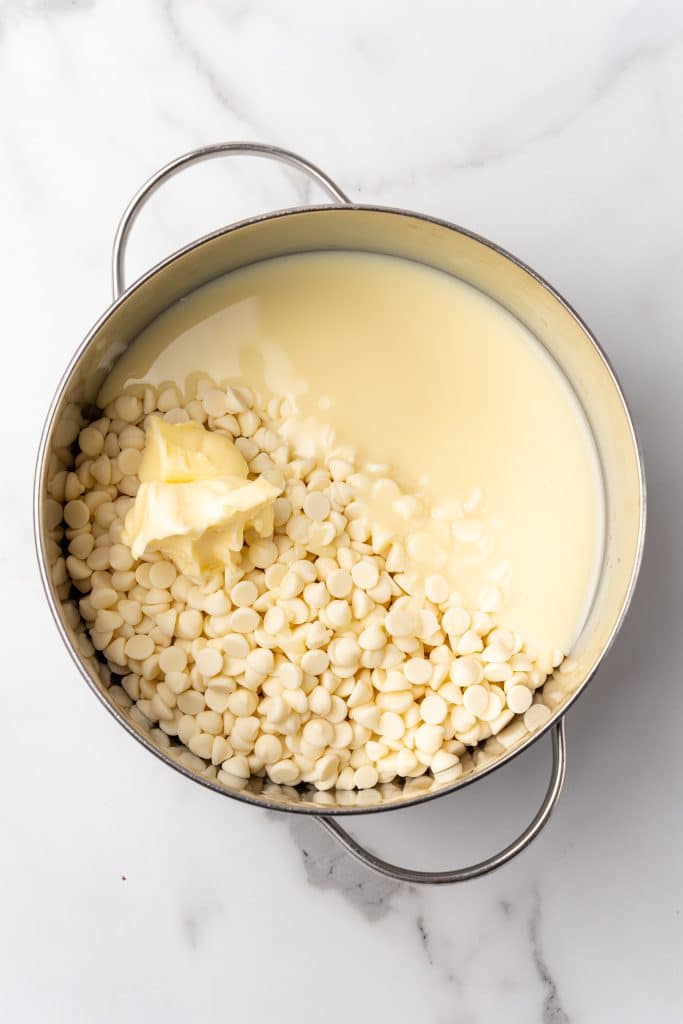 white chocolate melting in a silver pot