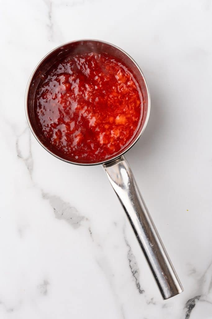 strawberry sauce in a small silver pot