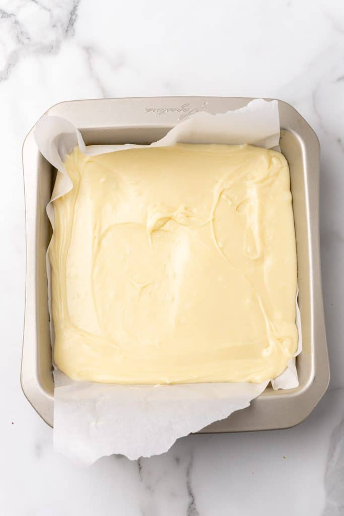 white chocolate in a parchment paper lined baking dish