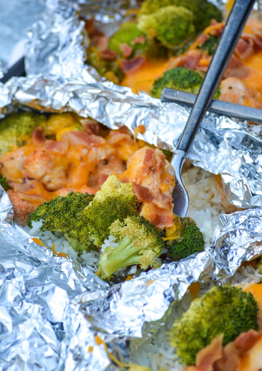 CHICKEN BROCCOLI AND RICE FOIL PACKETS with fork stuck in the middle