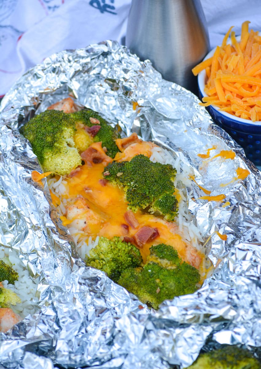 opened cheesy chicken broccoli rice foil packets on a sheet pan