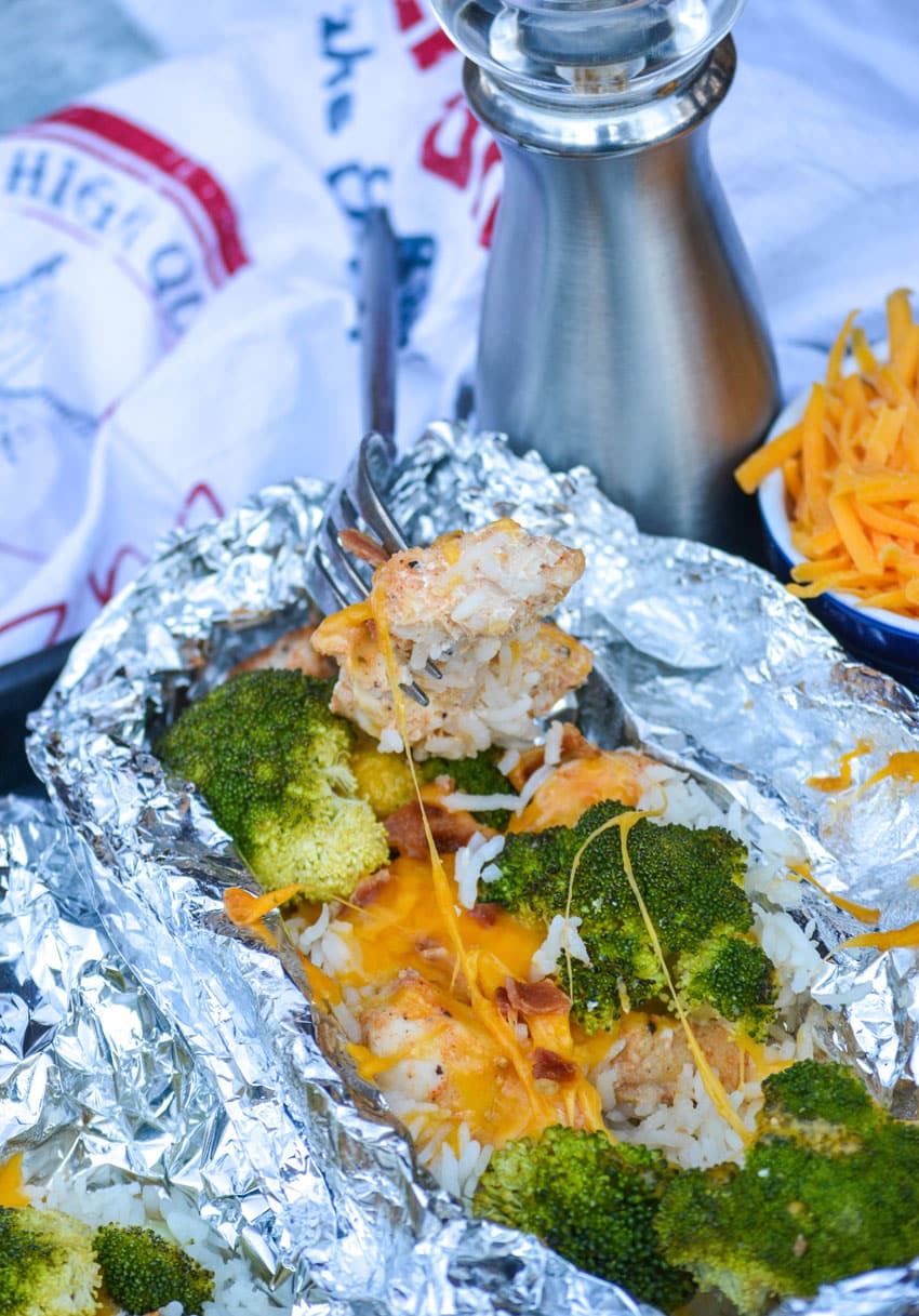 CHICKEN BROCCOLI AND RICE FOIL PACKETS with fork stuck in the middle