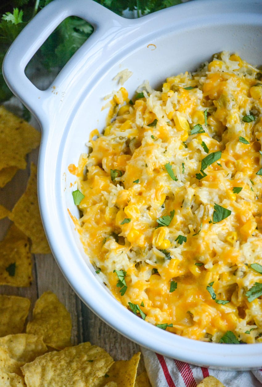 cheesy cilantro and sour cream rice in a white serving bowl