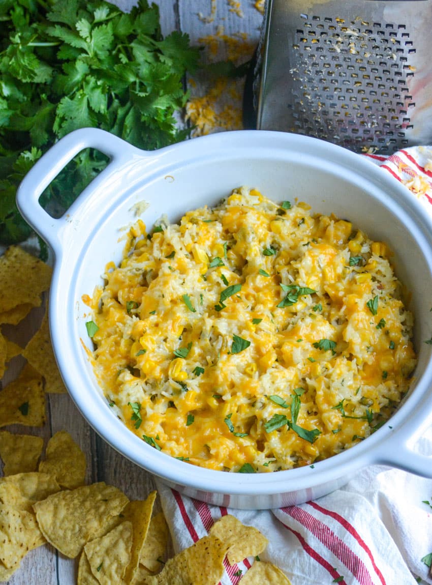 cheesy cilantro and sour cream rice in a white serving bowl