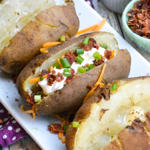 a fully loaded instant pot baked potato on a white platter