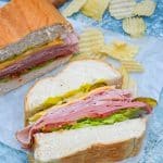 sliced Italian American sub sandwiches on white parchment paper