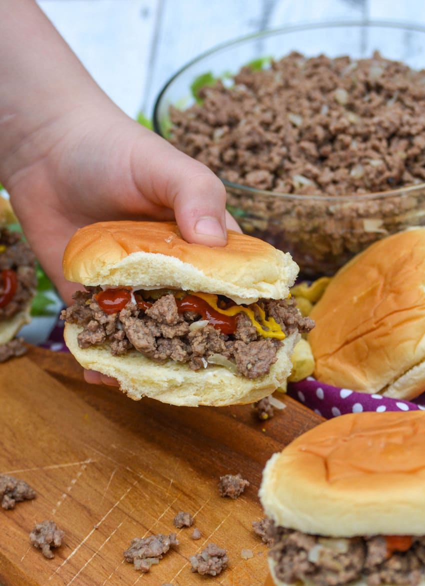 a hand holding up a copycat maid rite sandwich