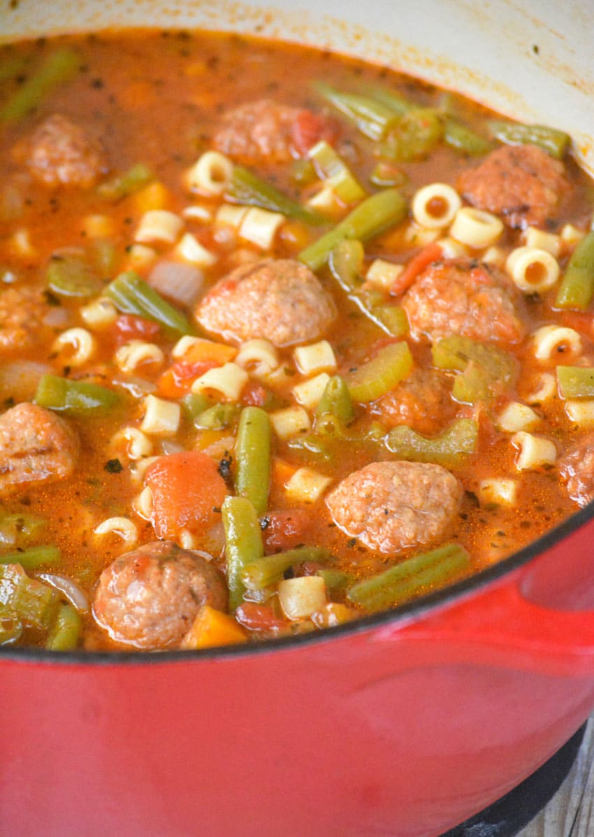 meatball vegetable soup in a red enameled cast iron pot