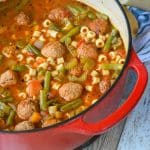 meatball vegetable soup in a red enameled cast iron pot