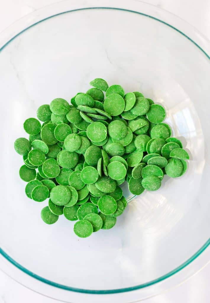 green candy melts in a glass mixing bowl